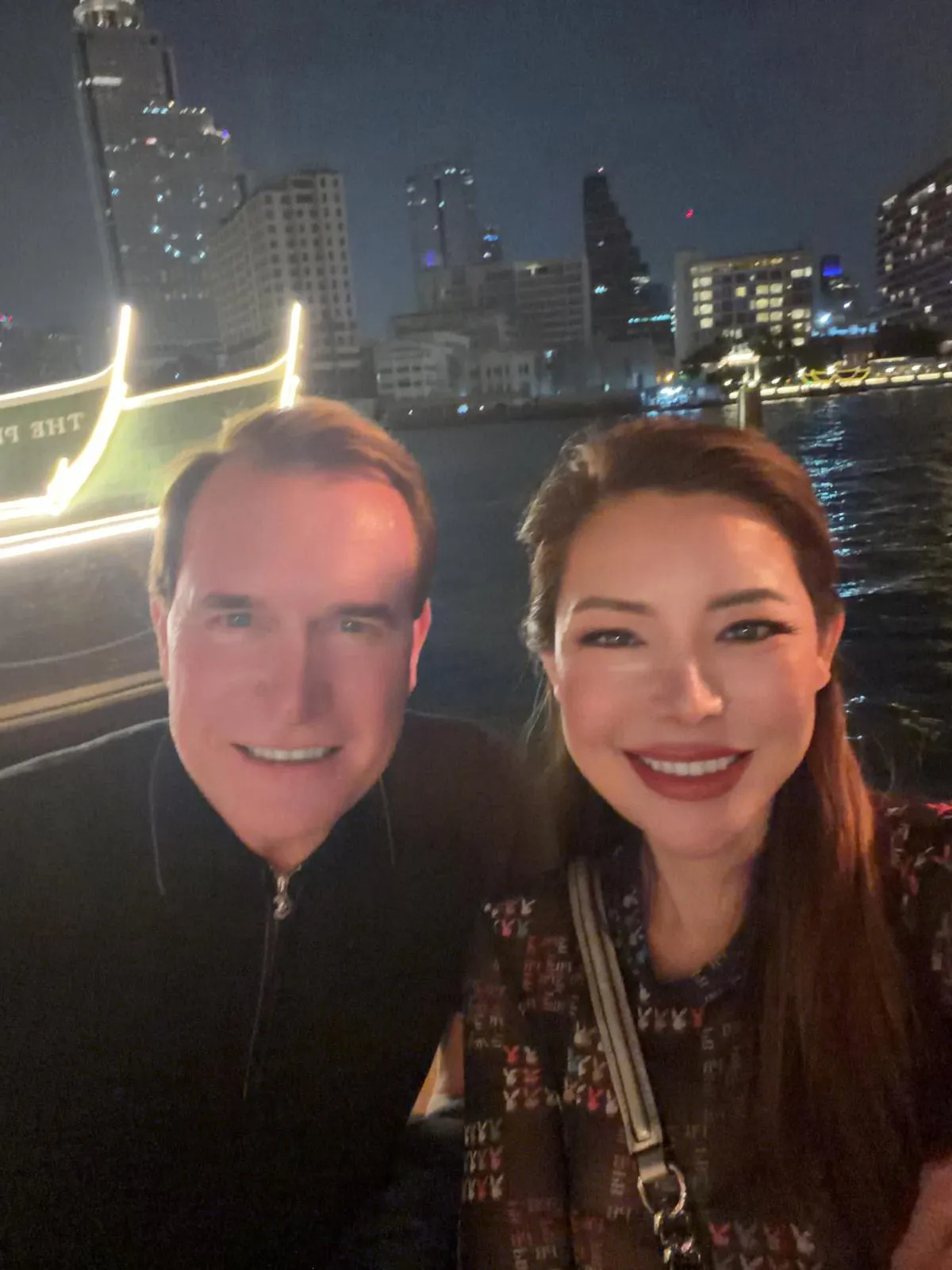 Sara Chau on the Chao Phraya River in Bangkok at night