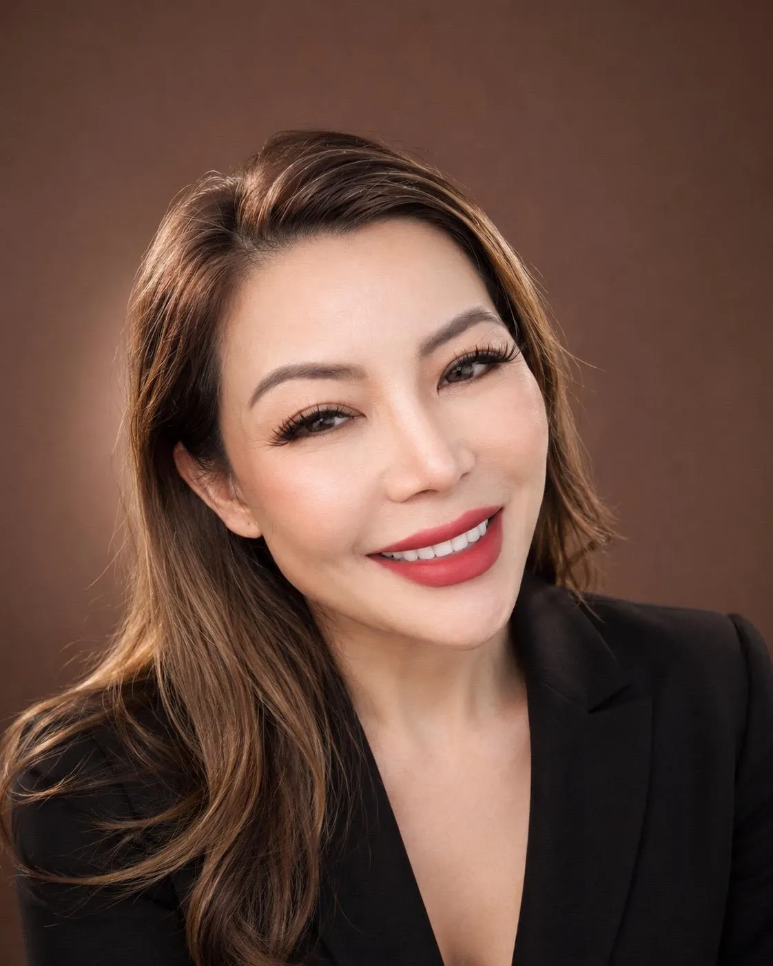 Sara Chau smiling in a black blazer